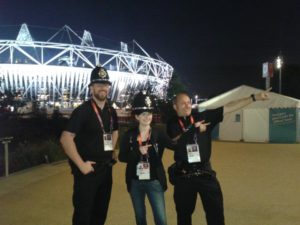 The image shows 2 police officers and me in the middle, wearing one of their hats, doing the Usain Bolt famous pose "to di world". 