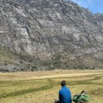 Dr Olly Bartlett sitting on a wetland in the Peruvian Andes.