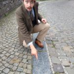 Pointing at a fossilised coral in a paving slab