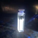 Image of liquid in a quartz cuvette that has bright white fluorescence