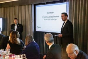 Photo of Matthew Wadge giving a speech in front of people, as he won the Silver Medal from the Institute of Materials