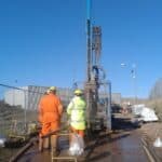 Catherine and collegues with drilling rig