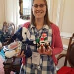 Laura holding soft toy mascots.