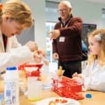 Lindsay extracting DNA from a strawberry at a family and friends event