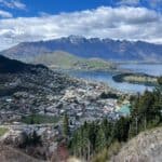 View of a New Zealand town with lake and mountains in the background