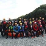 A group of emergency responders sat on inflatable boat in riverbed