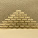 Petri dishes filled with agar stacked in a pyramid to dry.